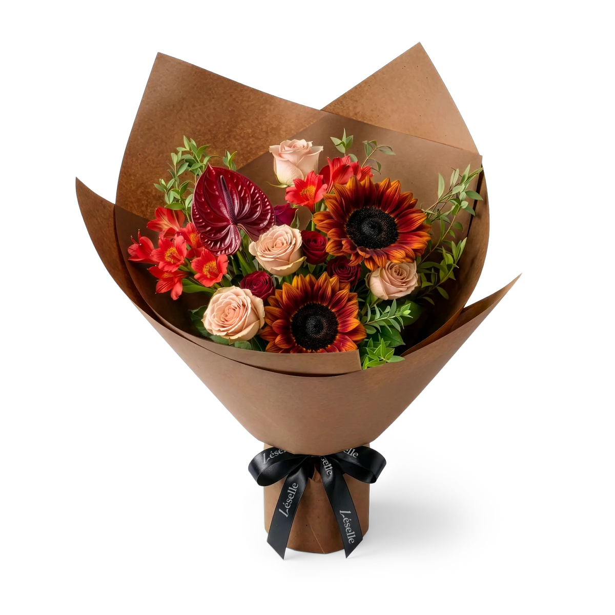 A wrapped flower bouquet featuring burgundy sunflowers, cappuccino roses, a dark red anthurium, and green foliage, wrapped in a brown paper sleeve with a black ribbon, on a transparent background.